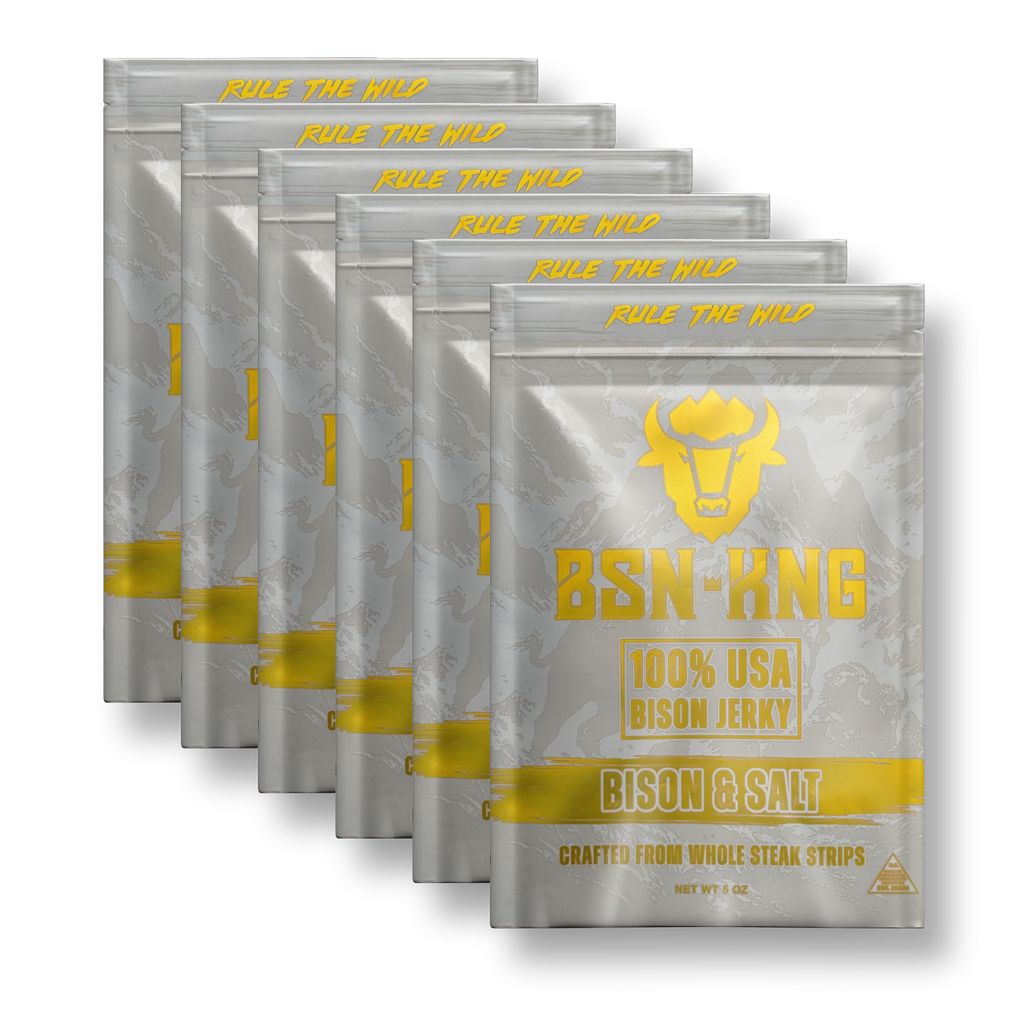 Multiple packages of BSN-KNG 100% USA Bison Jerky with gold text on a white background