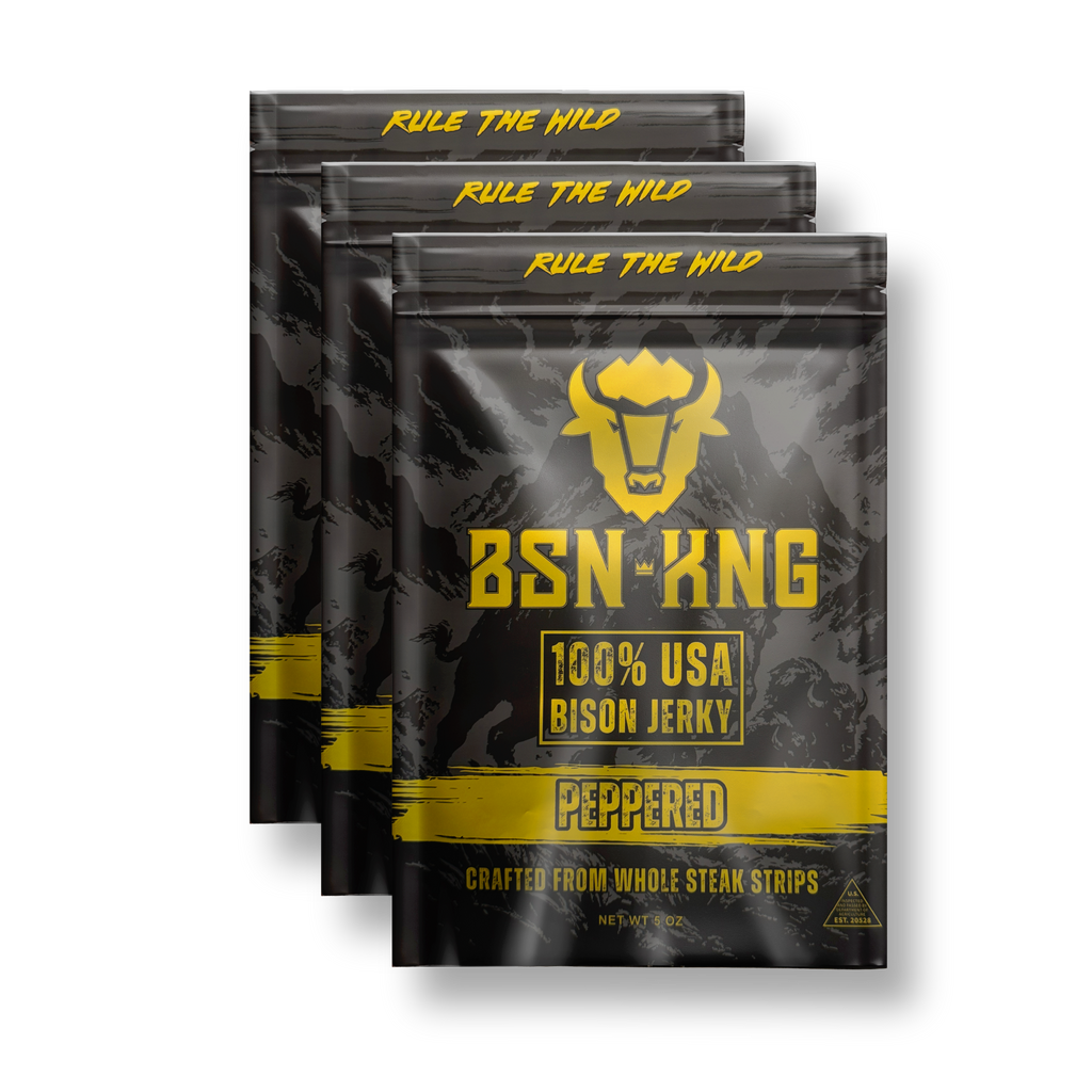 Three packages of BSN King 100% USA Bison Jerky with peppered flavor on a white background.