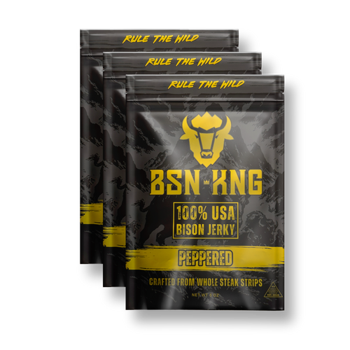 Three packages of BSN King 100% USA Bison Jerky with peppered flavor on a white background.