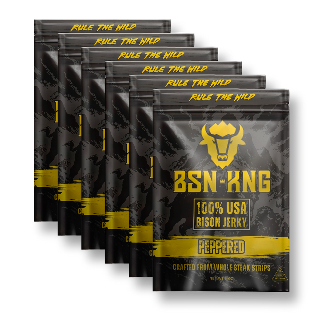 Multiple packages of BSN KNG peppered bison jerky on a white background